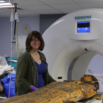 Jenny with the front of a coffin going into a CT scanner